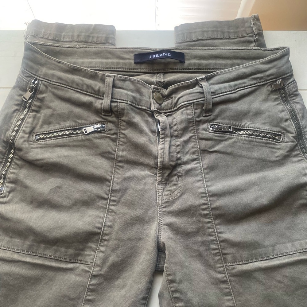 Grey capri with zip pockets slits at bottom of legs a little stretched out
